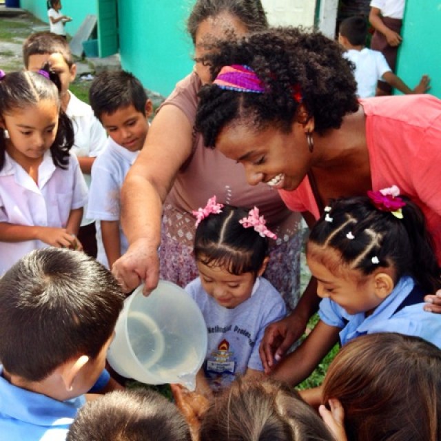 Group of Belizien children and two adult women.